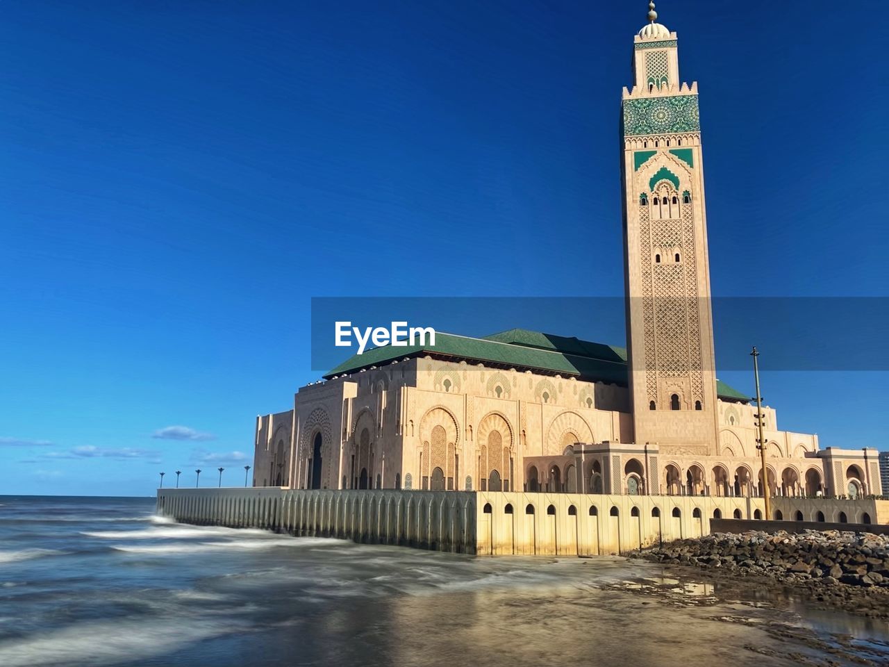 architecture, landmark, built structure, sky, water, travel destinations, building exterior, tower, blue, nature, travel, sea, building, clear sky, land, beach, history, religion, the past, tourism, no people, outdoors, place of worship, sunny, city, day, belief