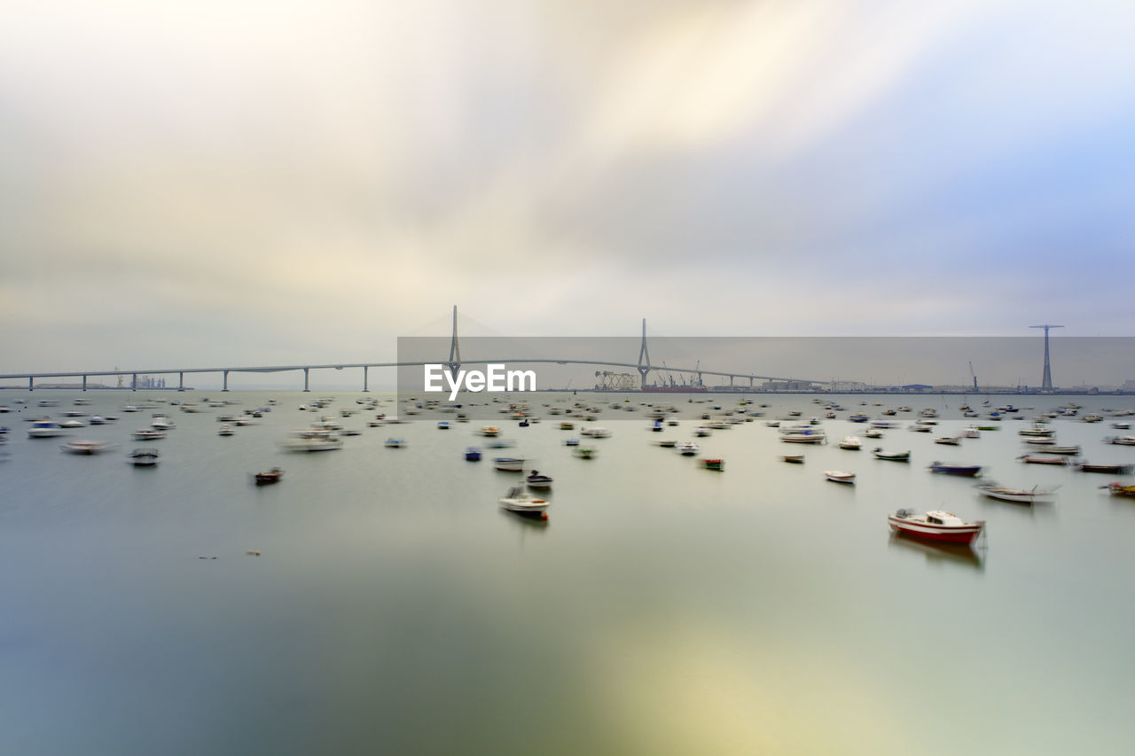 Sailboats in sea against sky