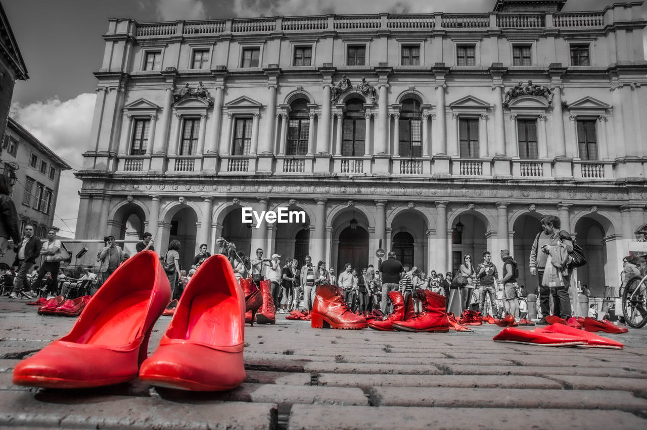 architecture, building exterior, built structure, red, city, travel destinations, building, arch, footwear, street, sky, nature, day, outdoors, tourism, history