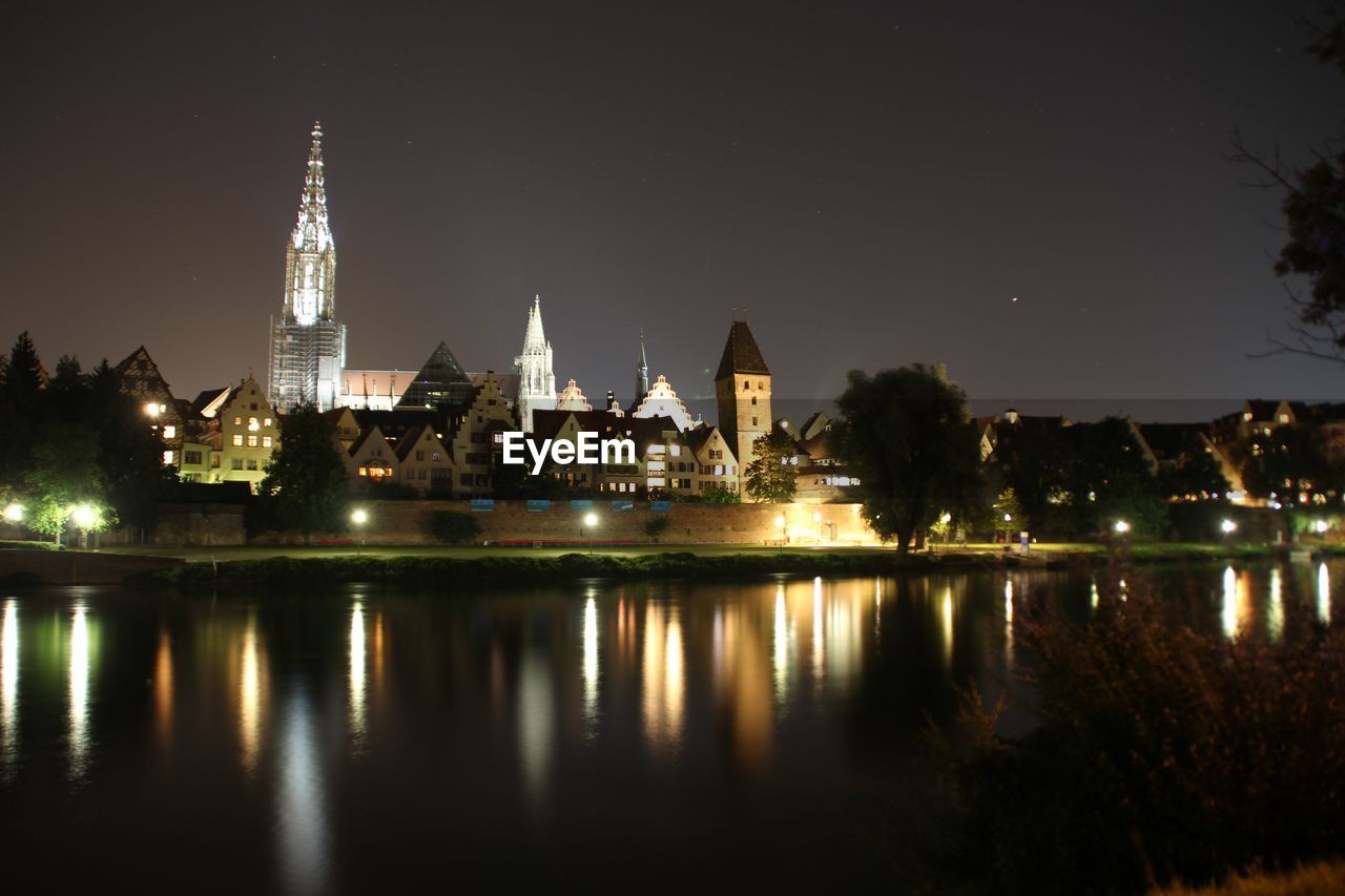 Reflection of illuminated buildings in water at night