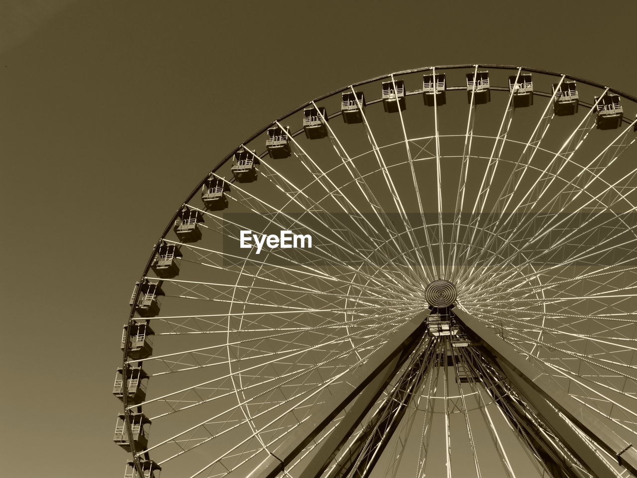 Low angle view of ferris wheel against clear sky