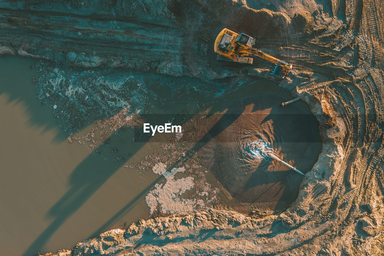 High angle view of earth mover digging land