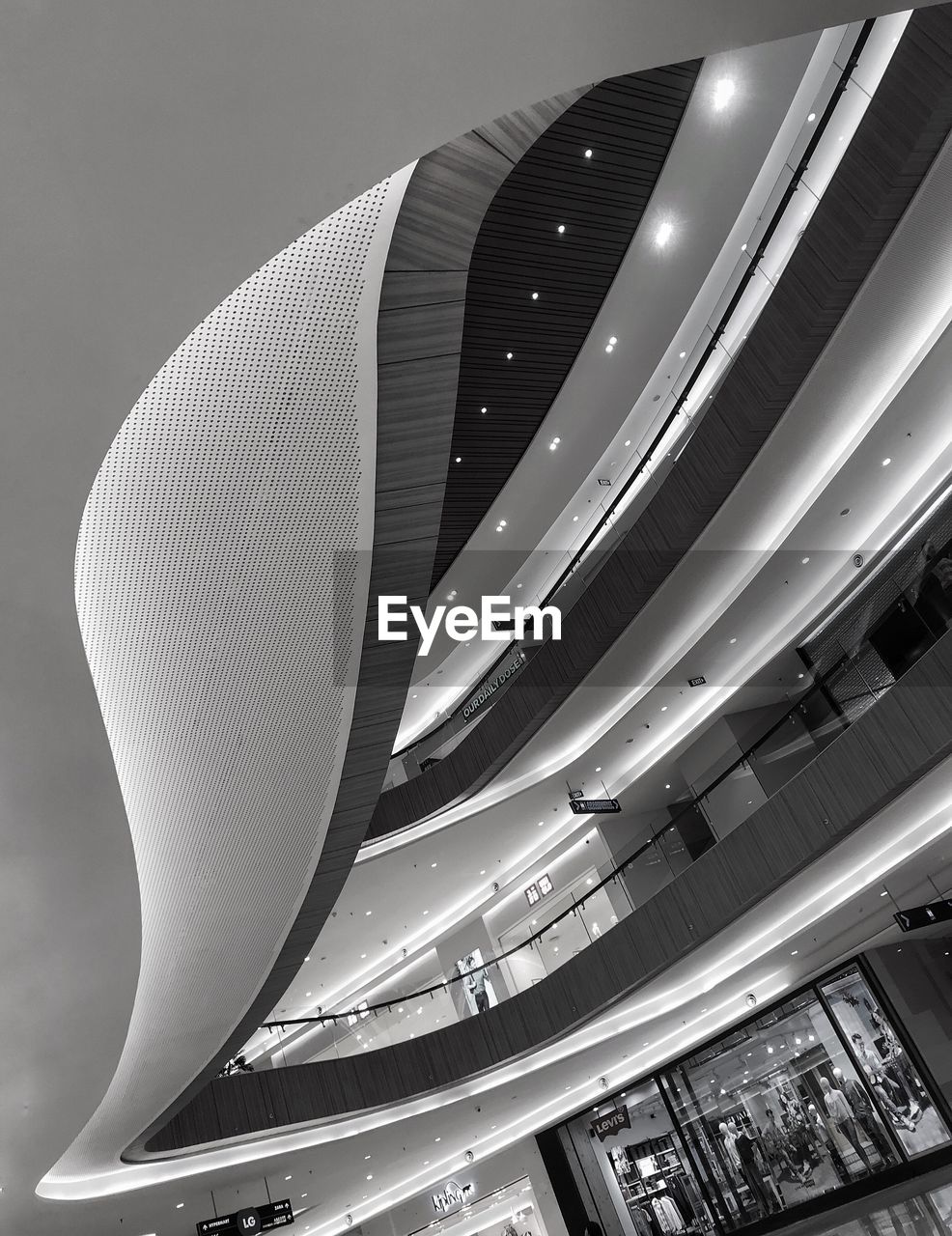 LOW ANGLE VIEW OF ILLUMINATED MODERN BUILDINGS AGAINST SKY