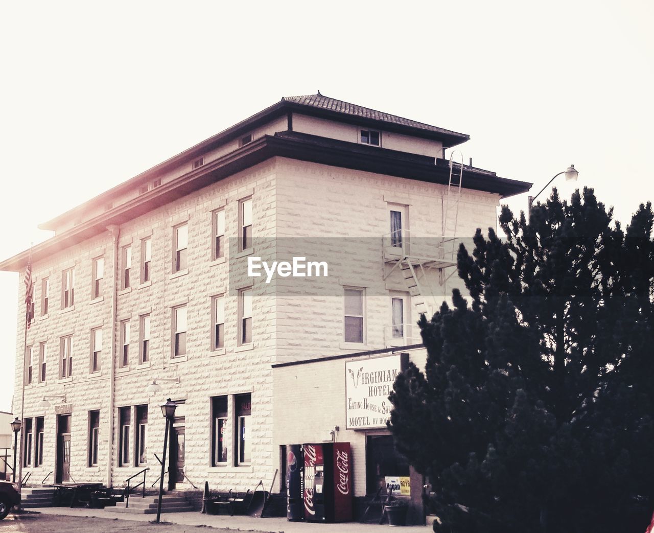 LOW ANGLE VIEW OF BUILDING AND STREET AGAINST SKY