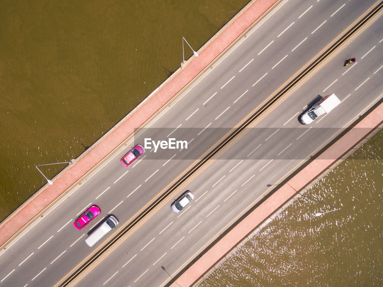 Aerial view of vehicles moving on bridge over sea