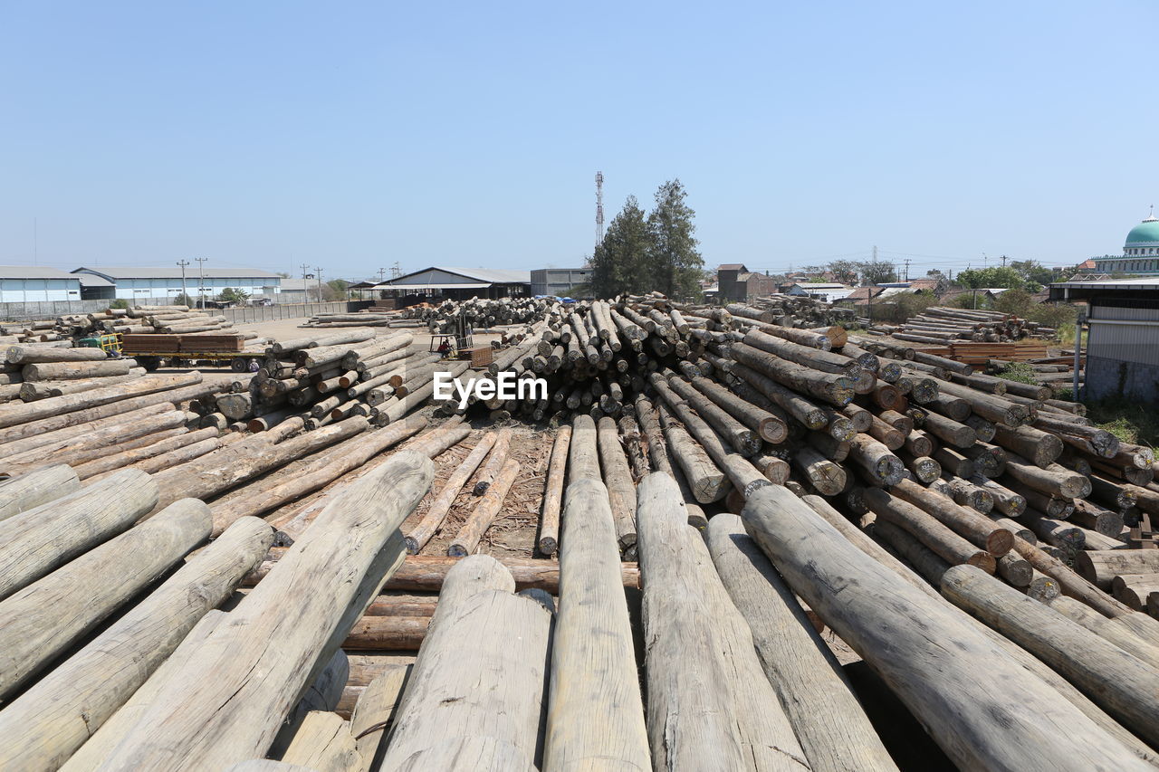 STACK OF LOGS AGAINST SKY