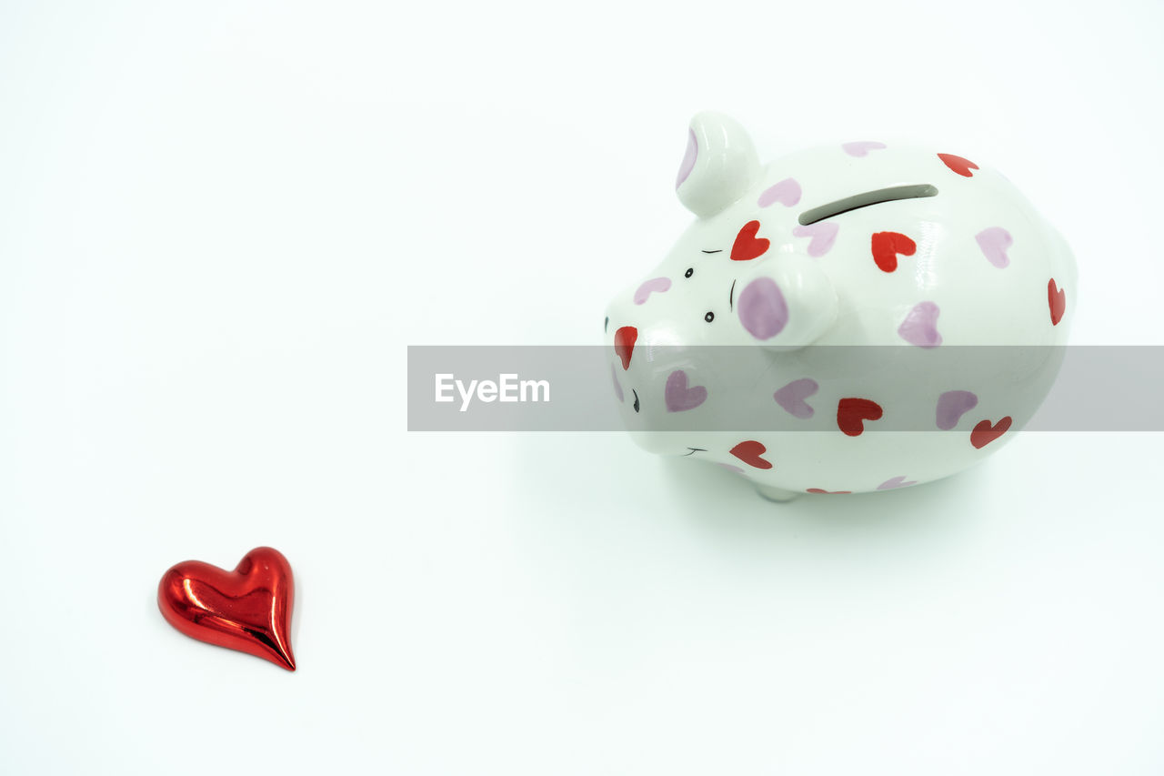 piggy bank, studio shot, white background, pink, positive emotion, finance, red, no people, investment, wealth, emotion, copy space, savings, heart shape, indoors, cut out, love, white, business, heart, single object