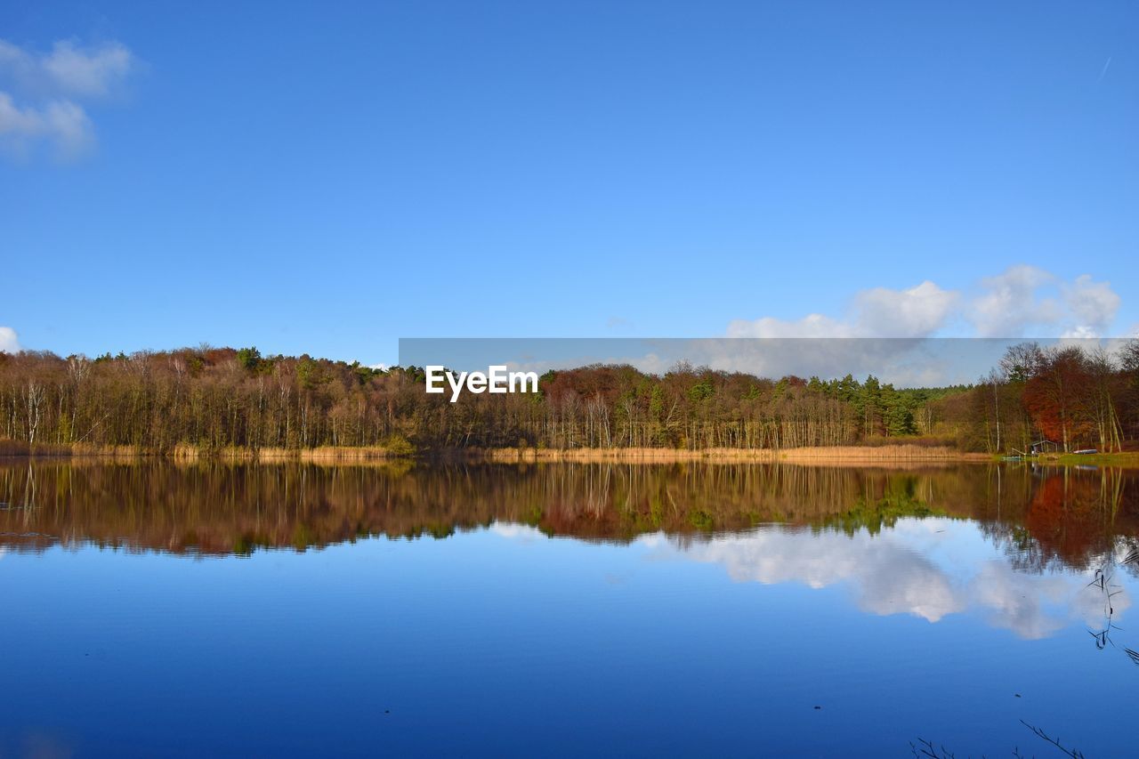 Scenic view of lake against blue sky