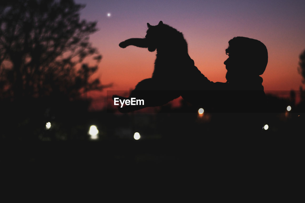 SILHOUETTE MAN AND WOMAN STANDING AT NIGHT