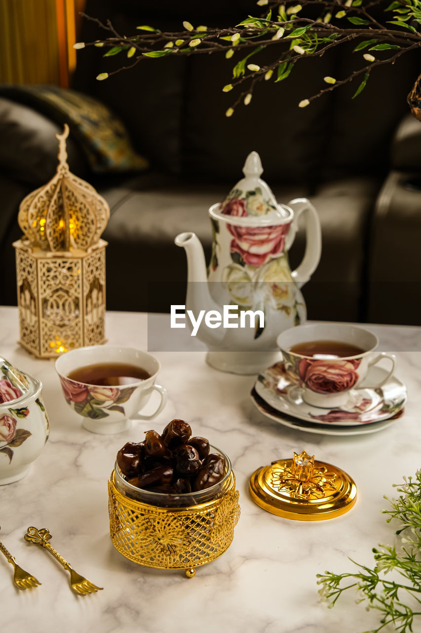 food and drink, tea, food, teapot, hot drink, tea cup, drink, cup, table, mug, afternoon tea, no people, indoors, ceramic, refreshment, meal, crockery, still life, sweet food, porcelain, plant, tableware, tradition, baked, fruit, healthy eating, saucer, sweet, dessert, nature, container, plate