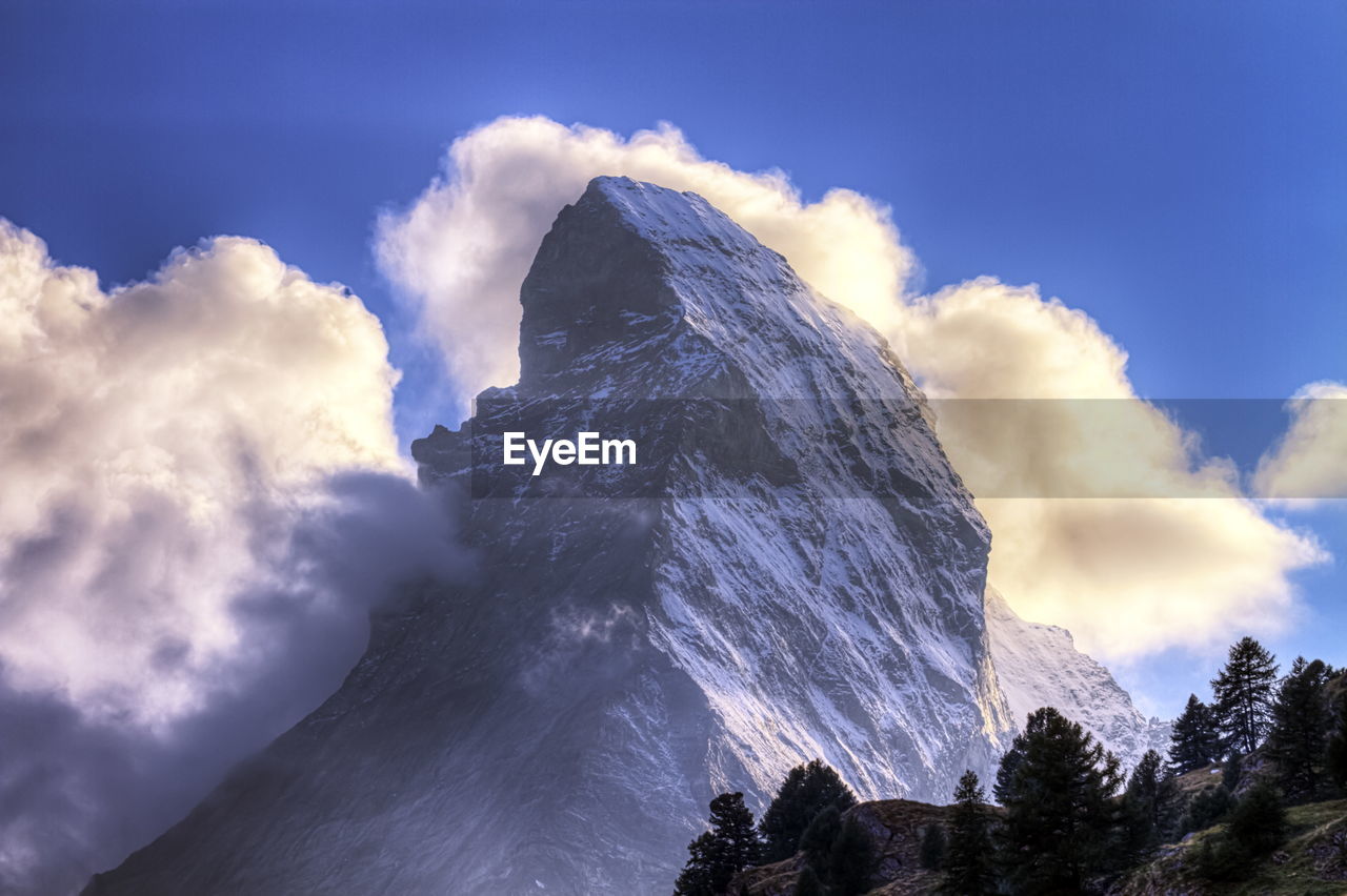 Matterhorn surrounded with clouds by day, zermatt, switzerland