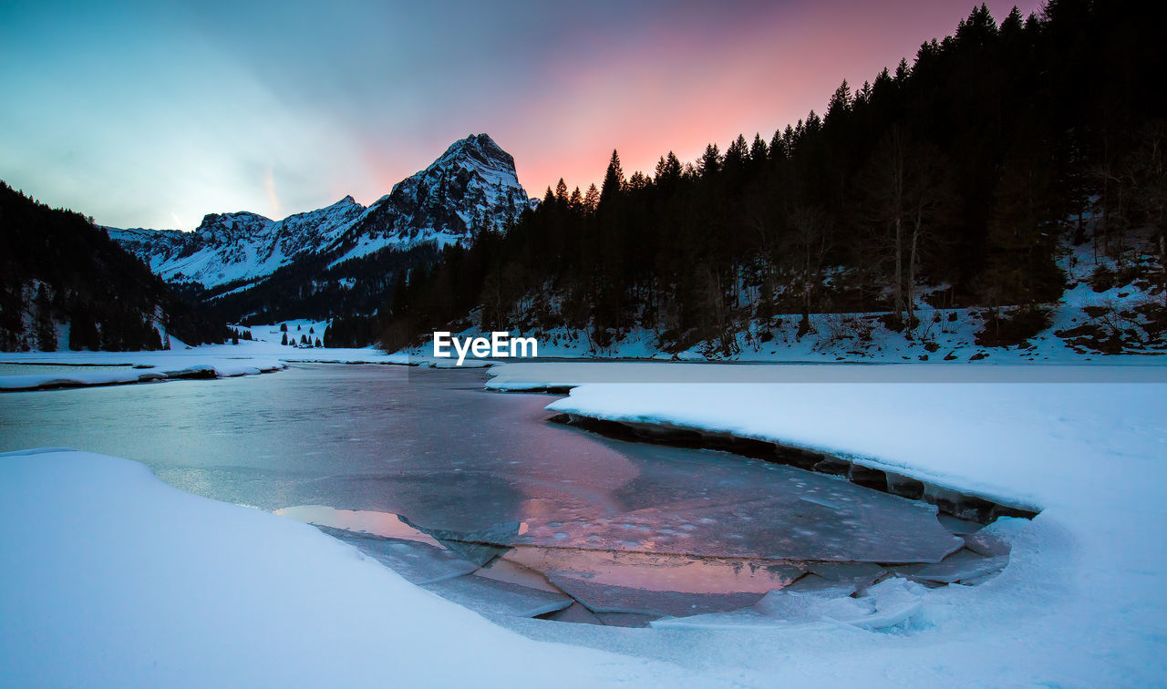 Frozen lake against sky during winter