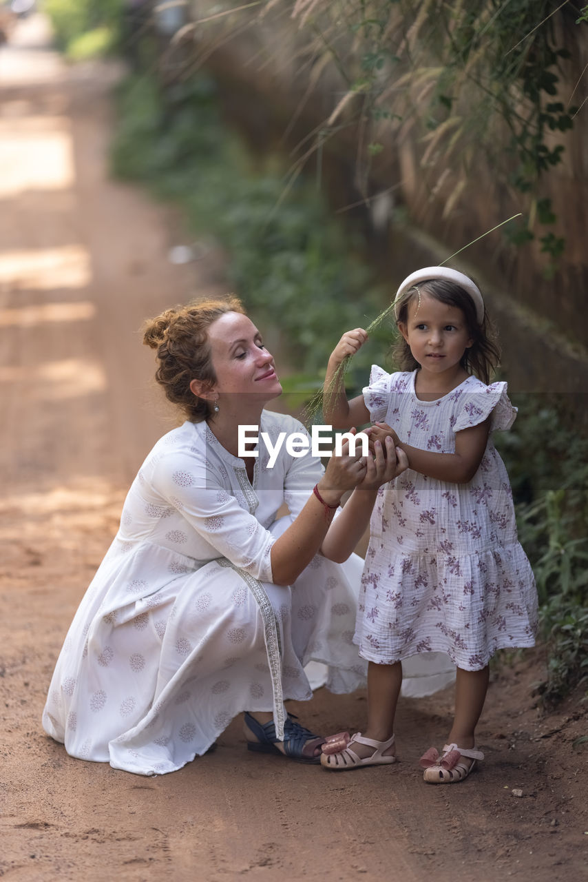 portrait of siblings playing with daughter