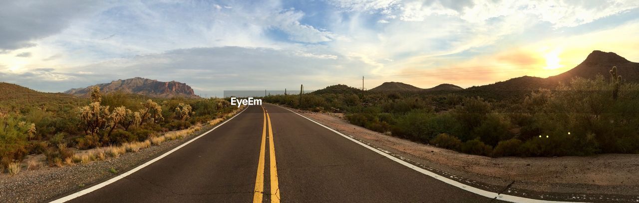 EMPTY ROAD AGAINST MOUNTAINS