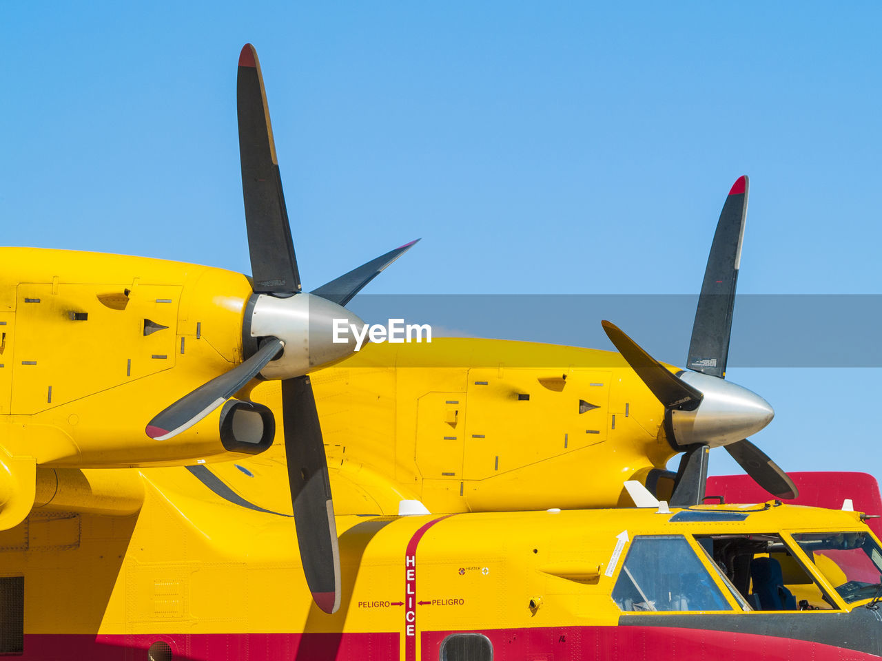 CLOSE-UP OF AIRPLANE AGAINST YELLOW SKY