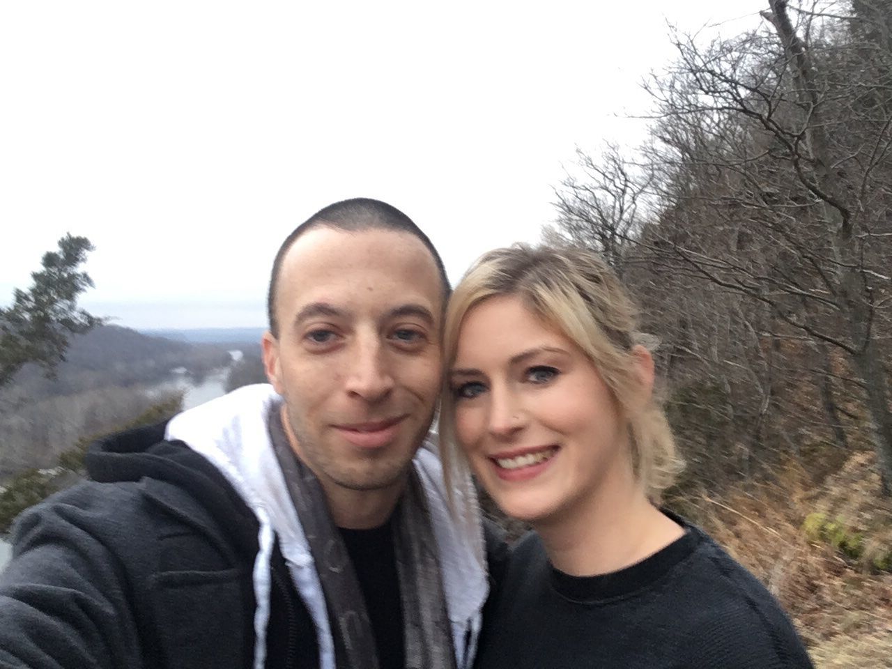 PORTRAIT OF SMILING YOUNG MAN AND WOMAN AGAINST SKY