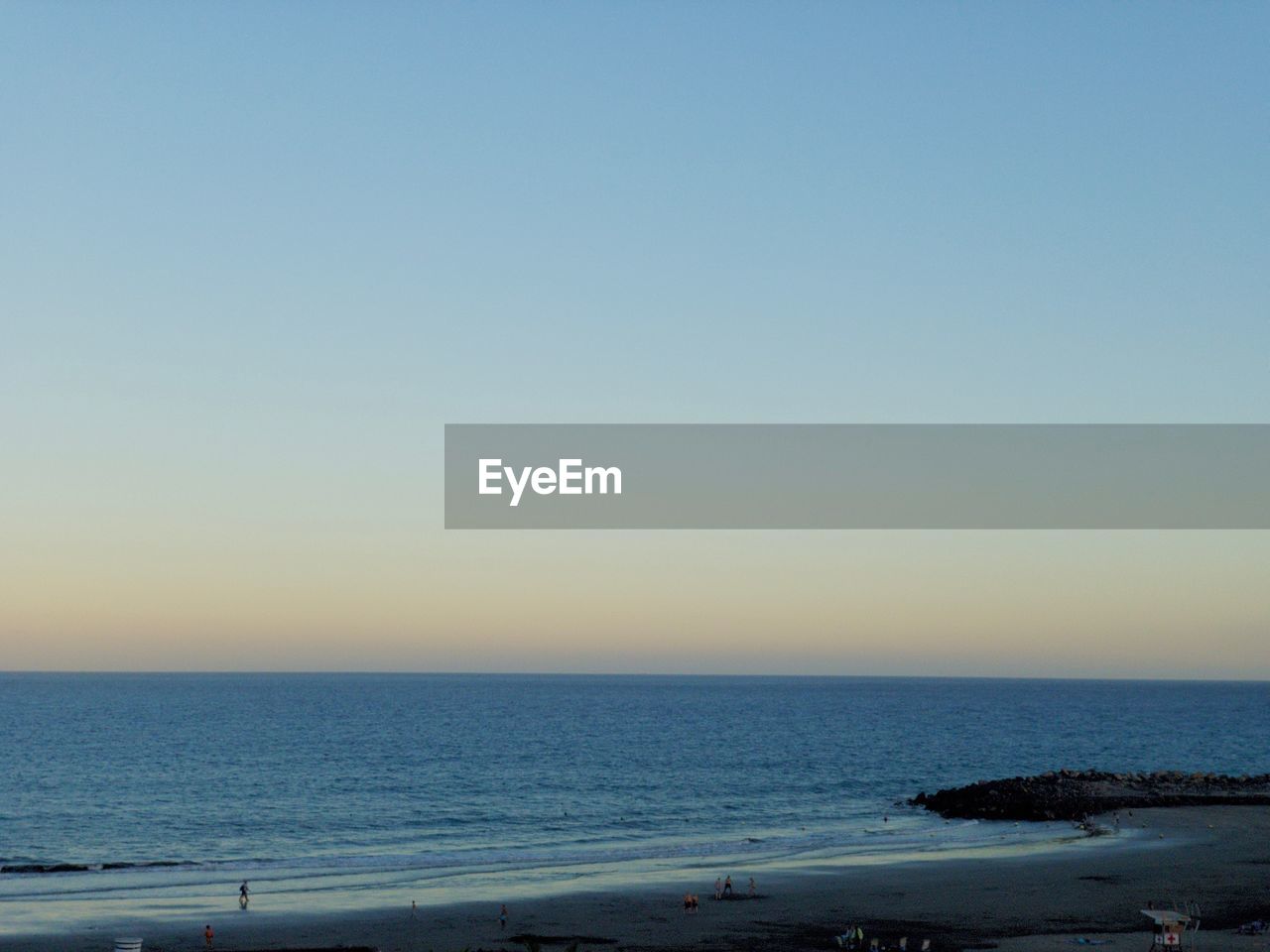 SCENIC VIEW OF BEACH AGAINST CLEAR BLUE SKY