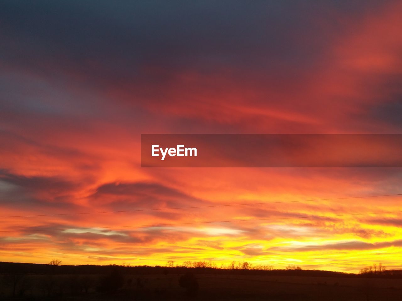 SCENIC VIEW OF LANDSCAPE AGAINST DRAMATIC SKY