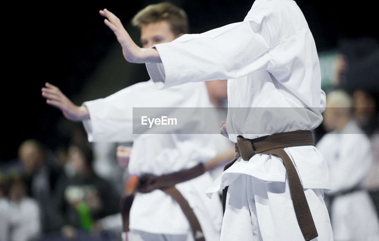 Karate men practicing in studio