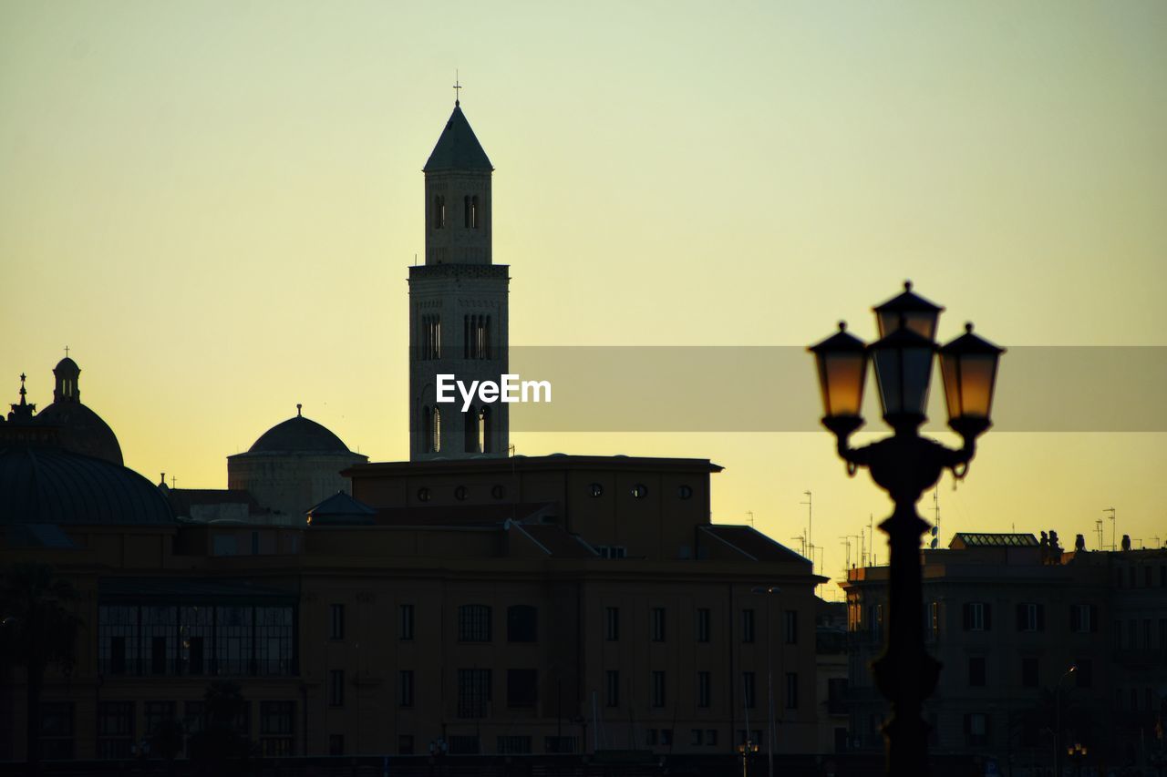 Buildings against sky at sunset