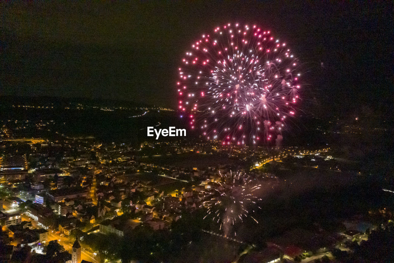 FIREWORK DISPLAY OVER CITY AT NIGHT