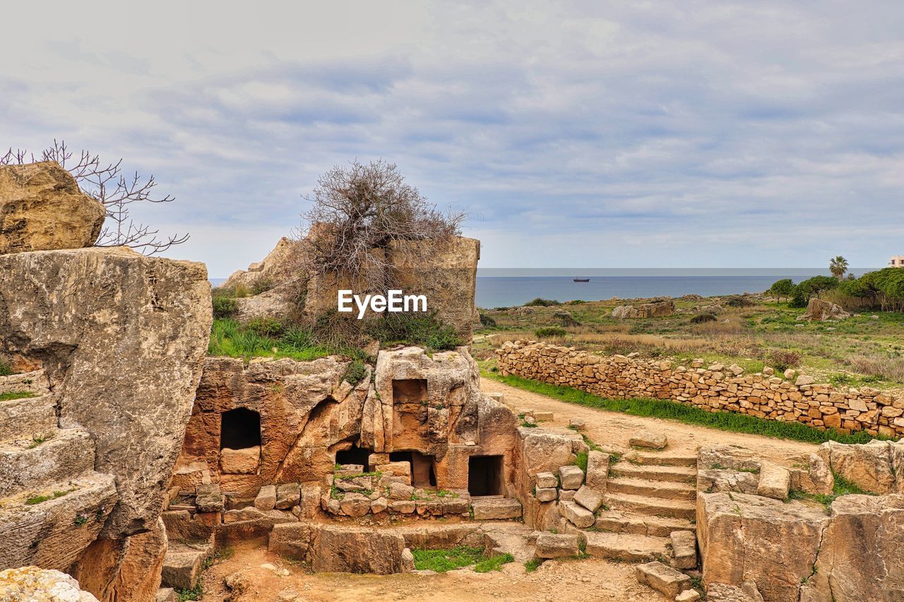 Old ruin by sea against sky