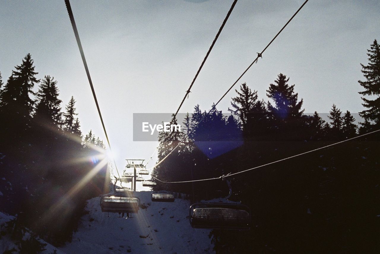 Cable cars against sky during sunset