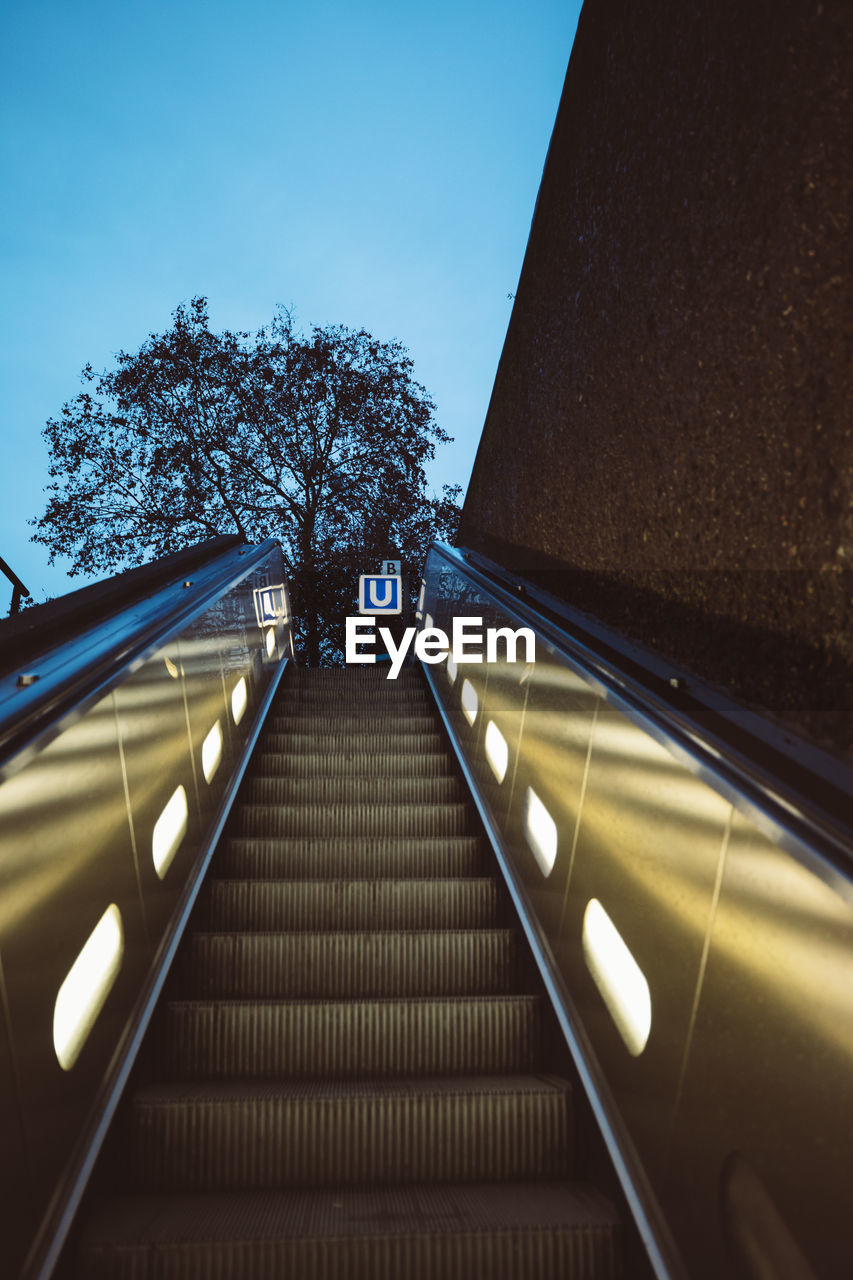 Low angle view of escalator against sky