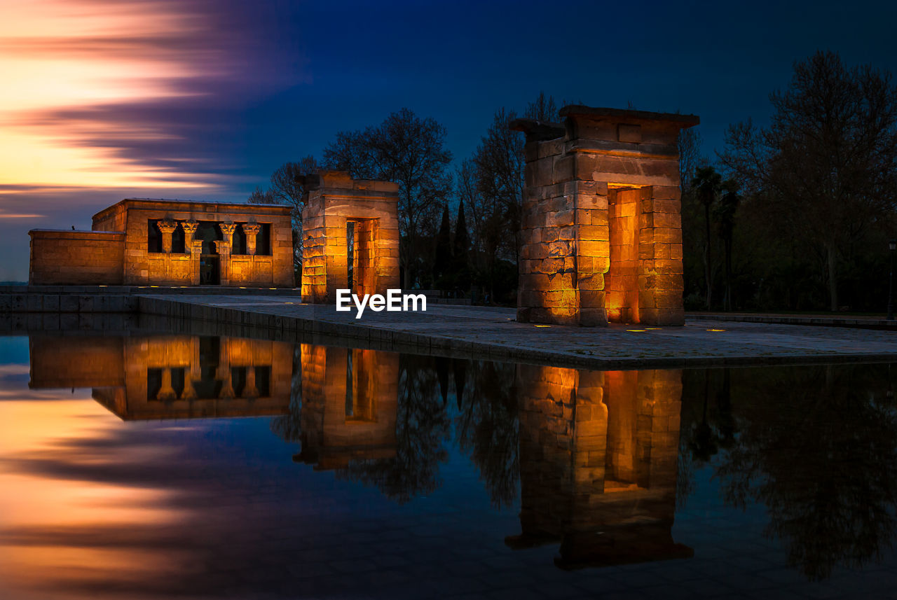 Reflection of illuminated temple of debod in pond