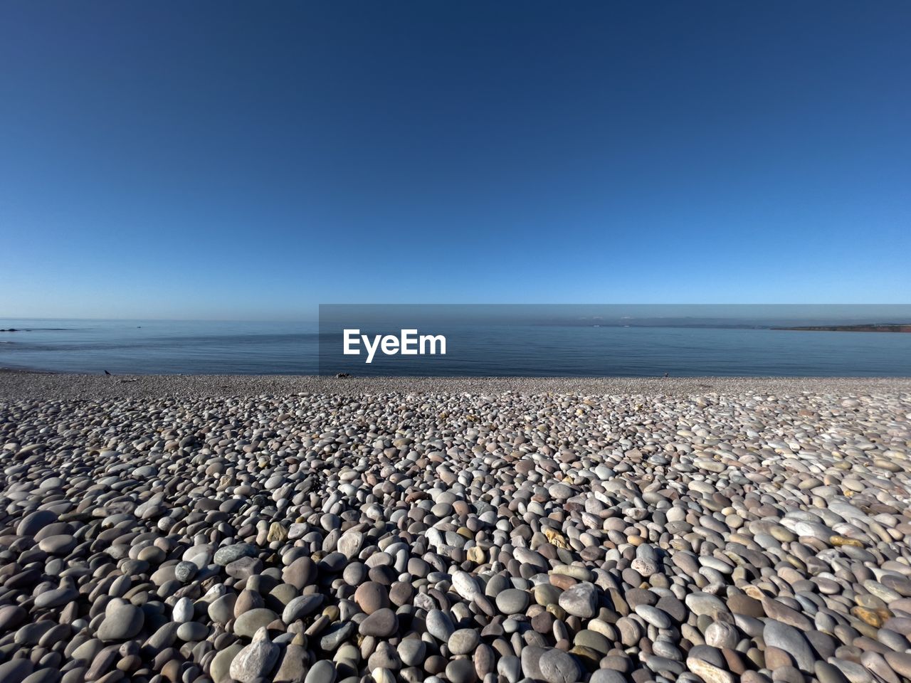 VIEW OF PEBBLE BEACH AGAINST CLEAR SKY