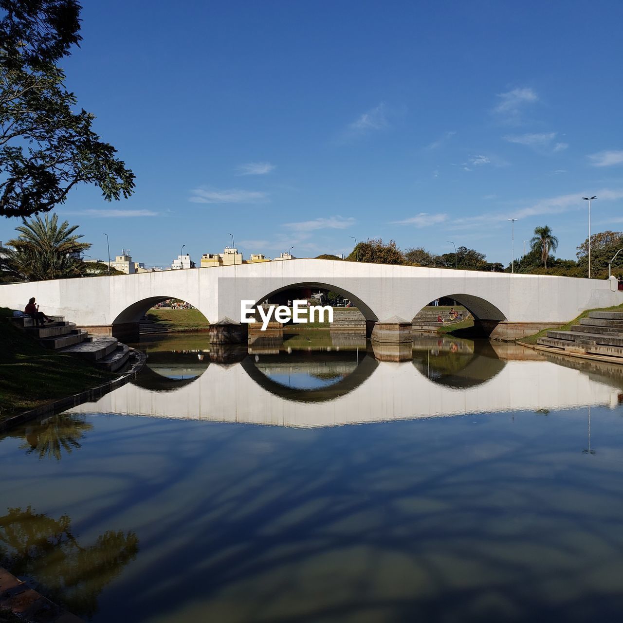 Arch bridge over river against sky