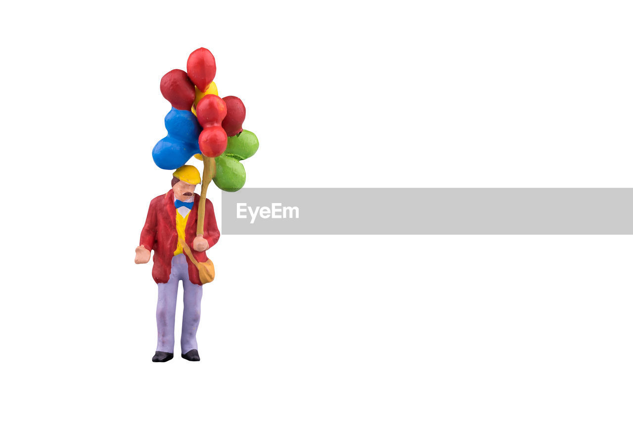 PERSON HOLDING COLORFUL BALLOONS