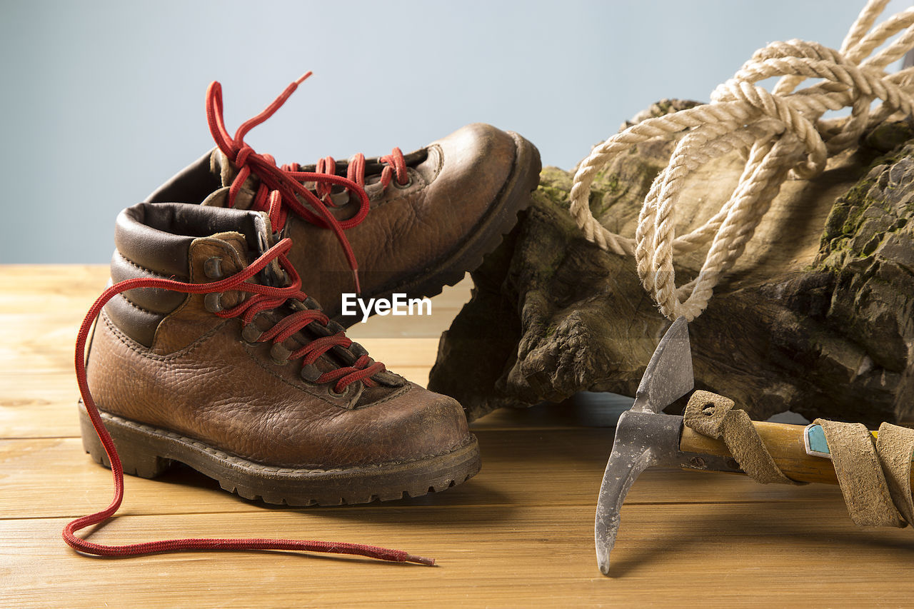 Close-up of shoes with equipment on wooden table