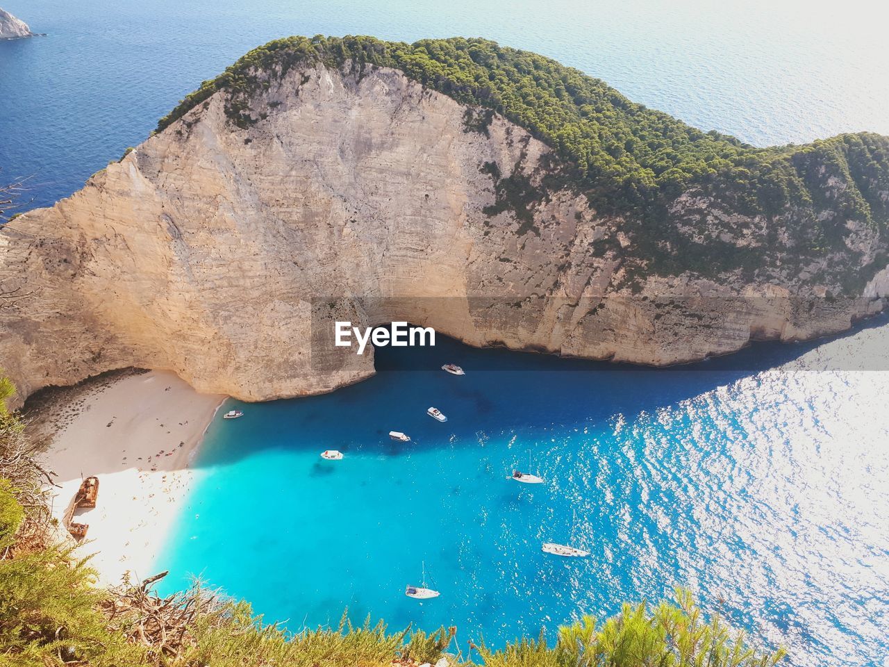 Scenic view of sea and mountain against blue sky