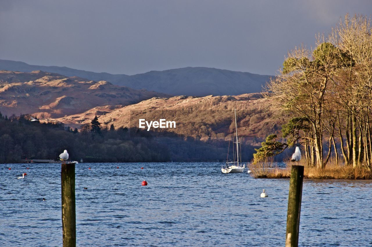 Scenic view of lake and mountains against clear sky