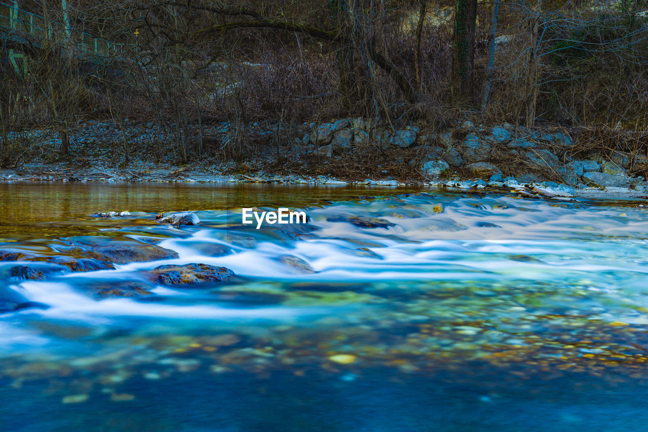 SURFACE LEVEL OF WATER FLOWING IN SUNLIGHT