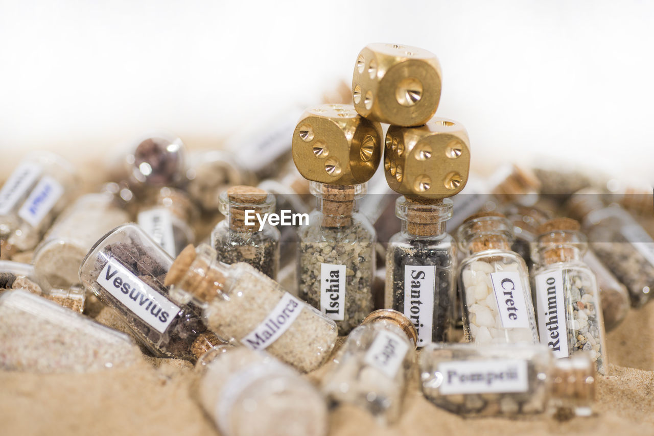 HIGH ANGLE VIEW OF BOTTLES IN CONTAINER ON TABLE