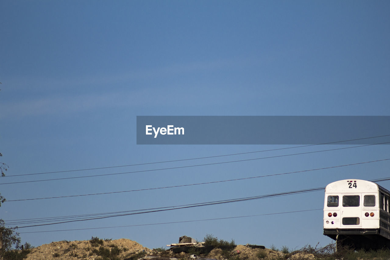 Low angle view of power lines against clear sky