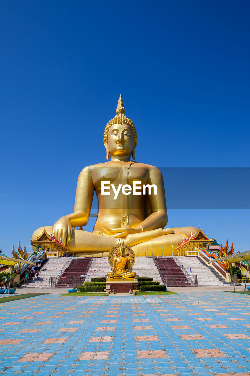 Statue of buddha against blue sky