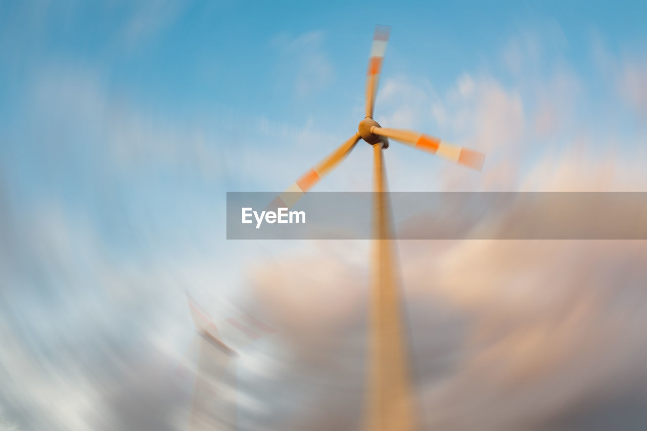 LOW ANGLE VIEW OF WINDMILLS AGAINST SKY