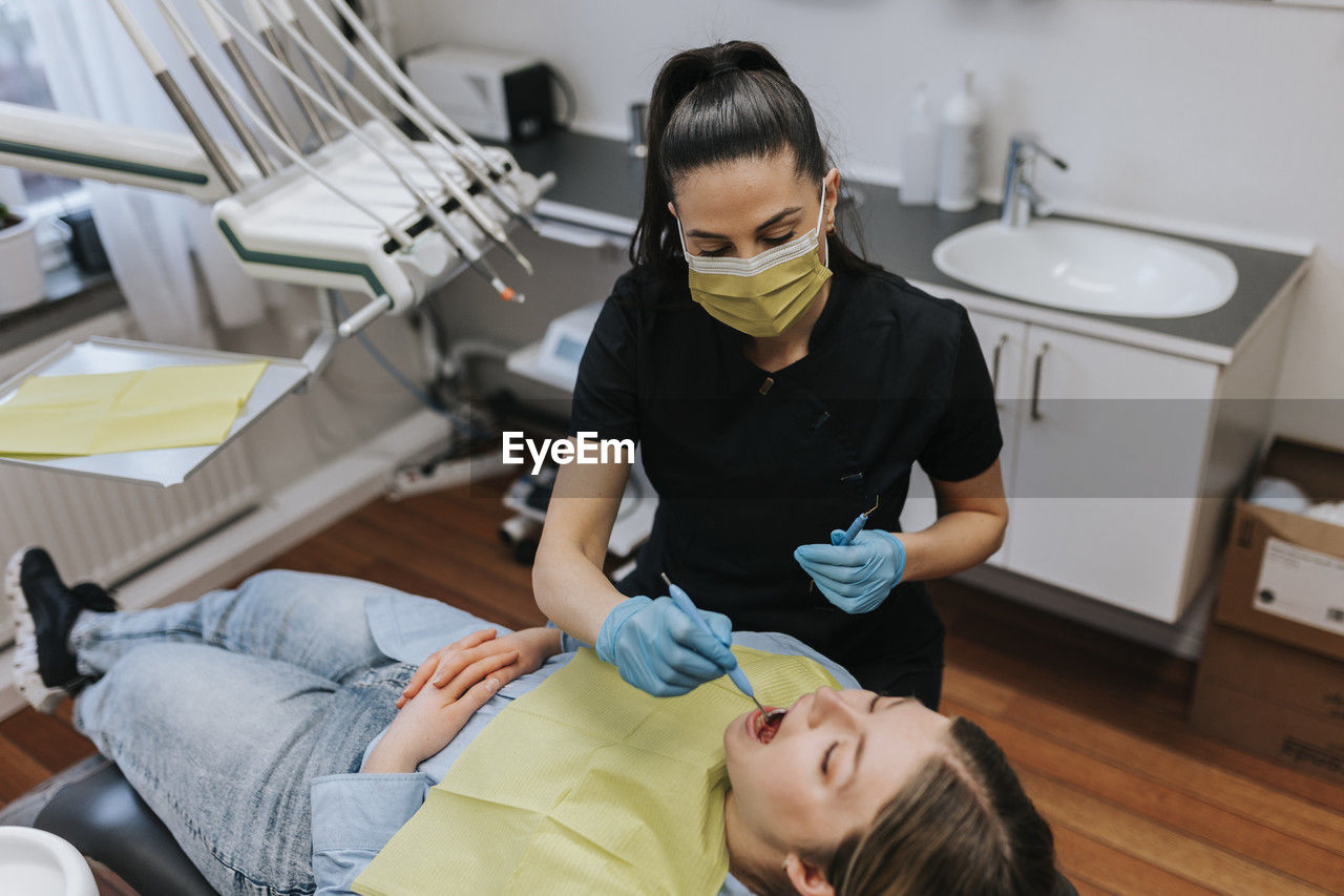 Female dentist with patient in dentist's office