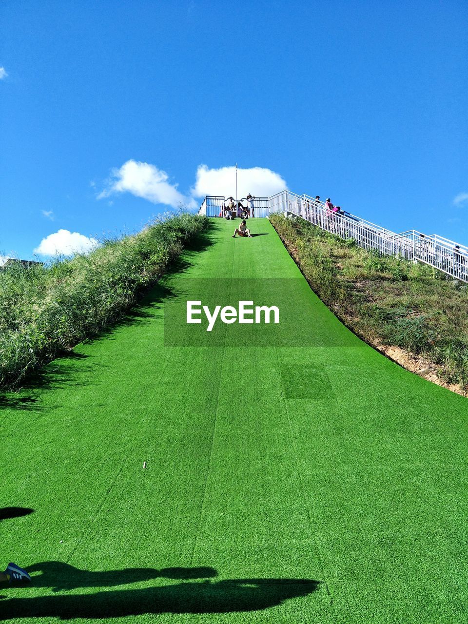 Low angle view of people on grass slide