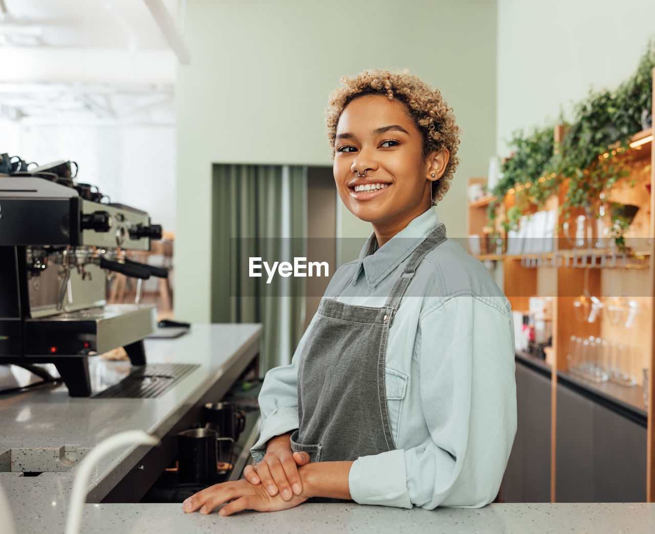 portrait of young woman using mobile phone in office