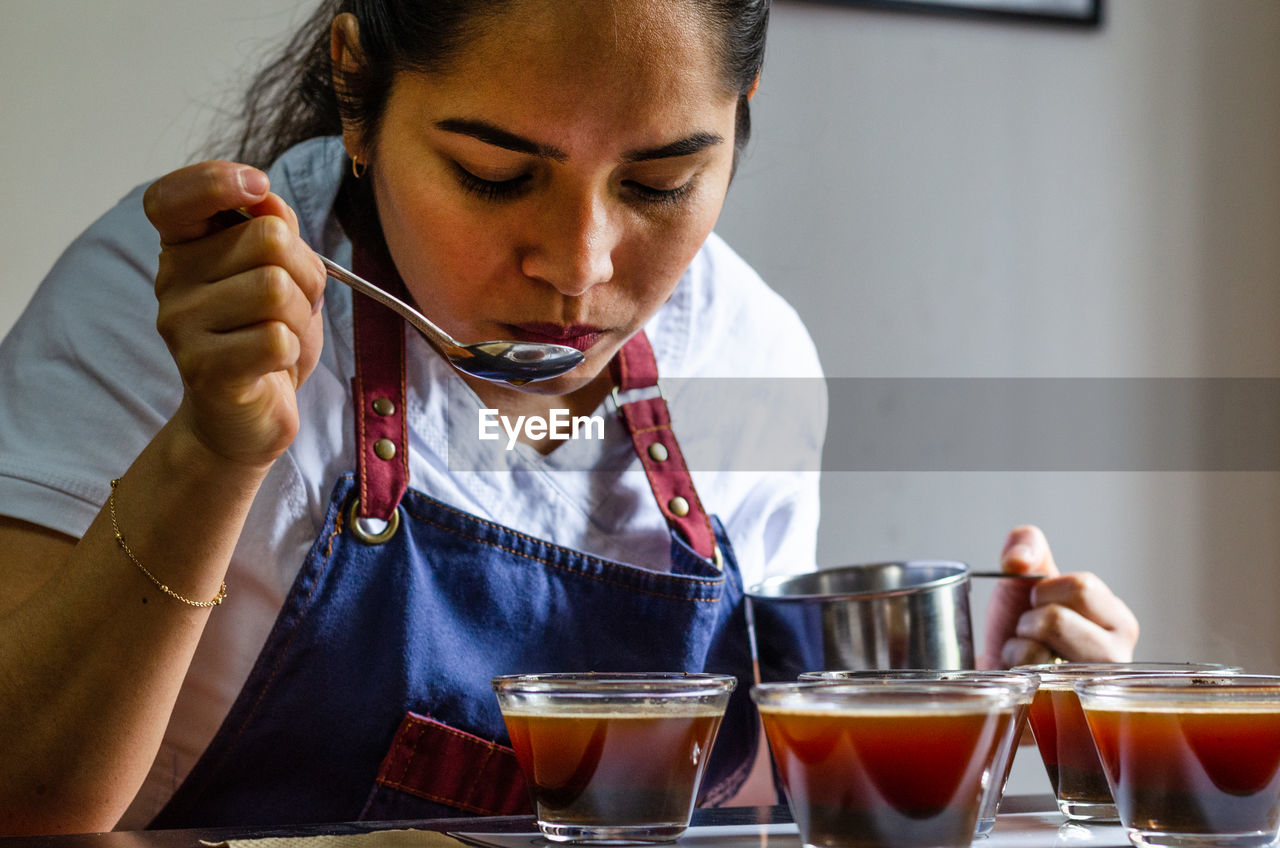 CLOSE-UP OF A WOMAN DRINKING GLASS WITH DRINK