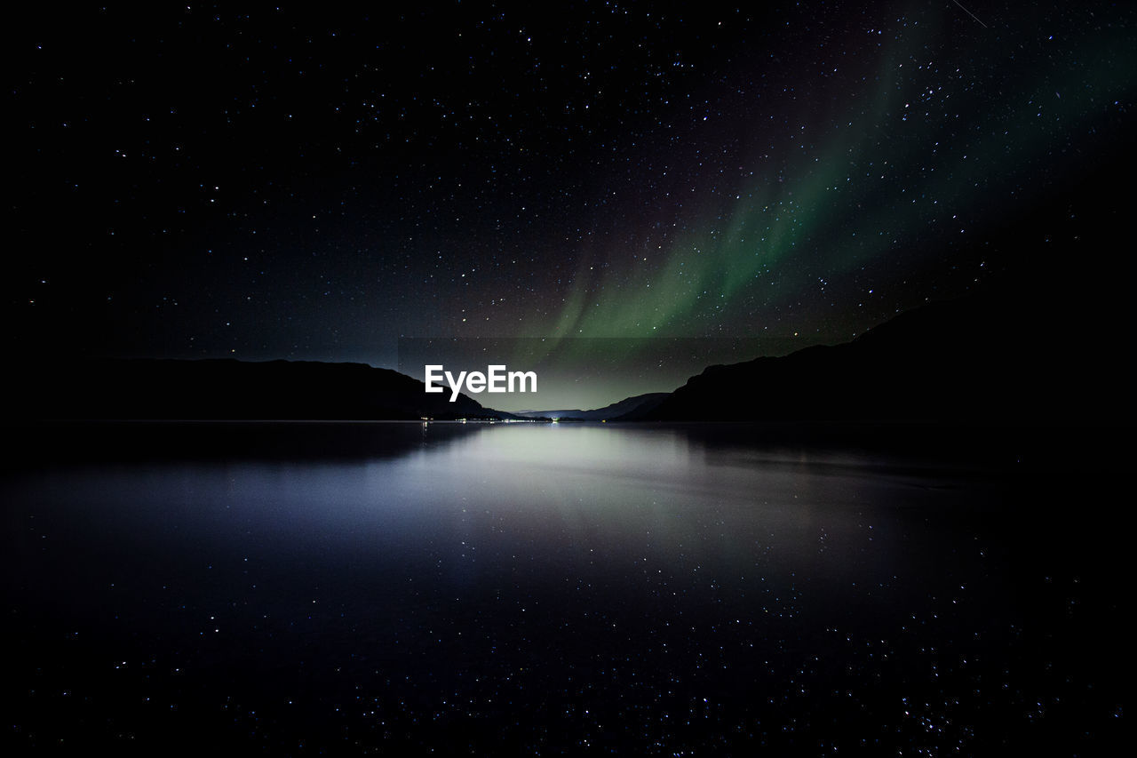 SCENIC VIEW OF LAKE AGAINST STAR FIELD IN SKY AT NIGHT