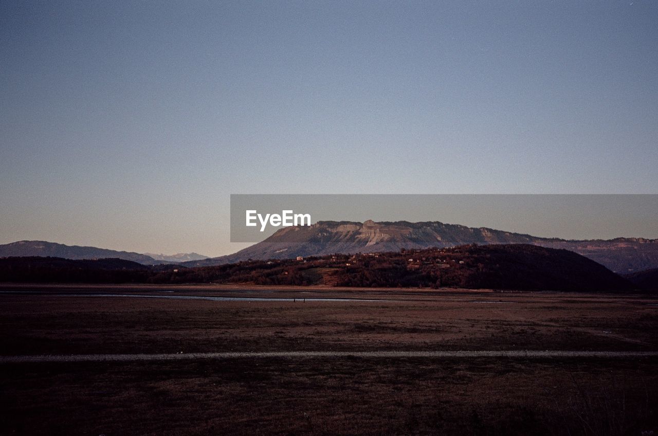 Scenic view of mountains against clear blue sky