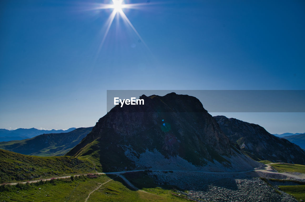 Scenic view of mountains against clear blue sky