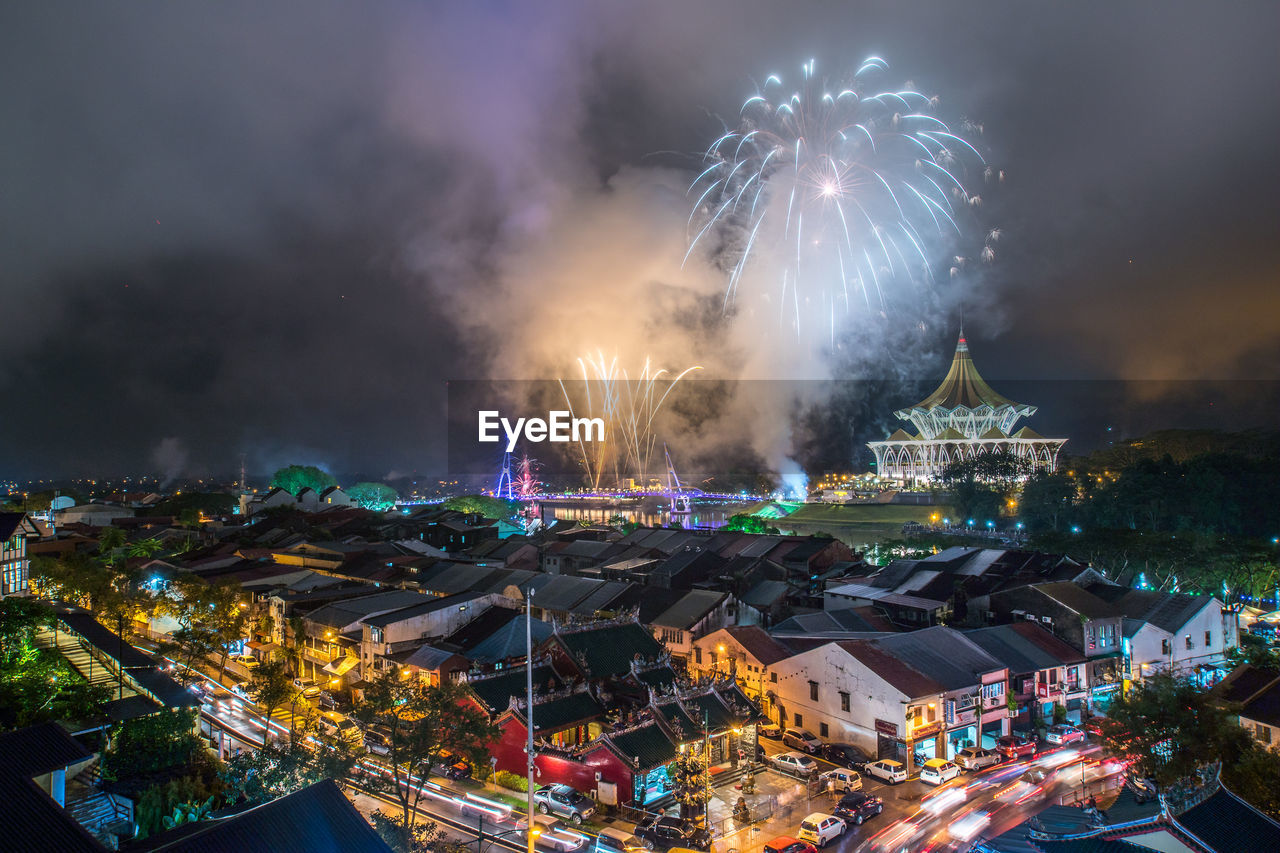 High angle view of firework display at night