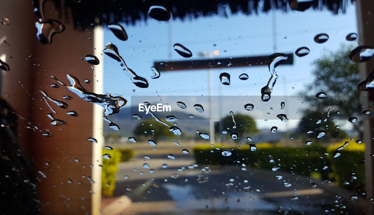 Full frame shot of wet glass window during car wash. 