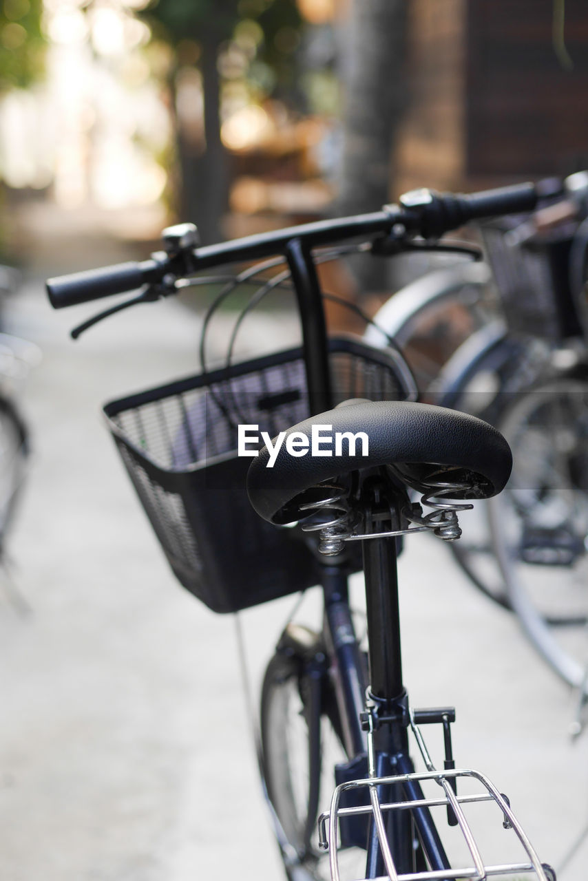 CLOSE-UP OF BICYCLE PARKED IN STREET